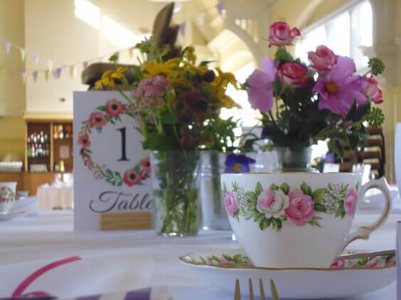 Teacup with floral jam jar table decoration